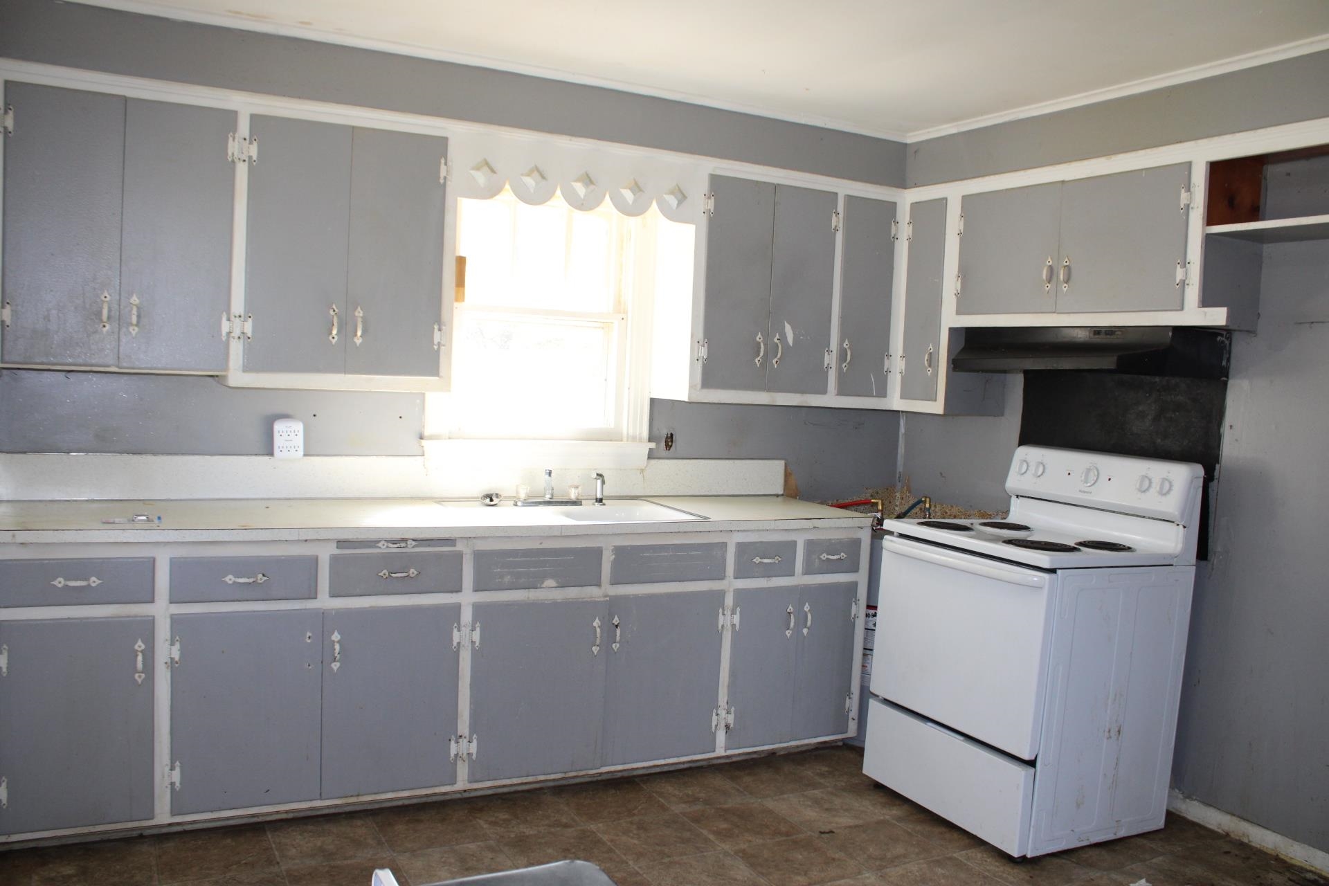 1027 Lynn School Road Ripley, TN 38063 - Photo 10 of 26 a kitchen with a stove and a sink