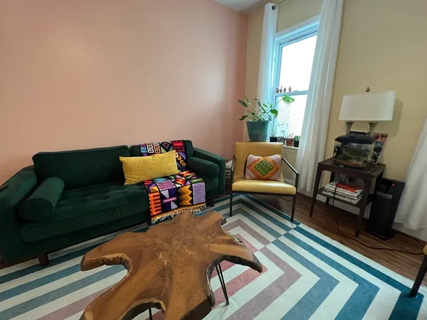 a bedroom with bed and wooden floor