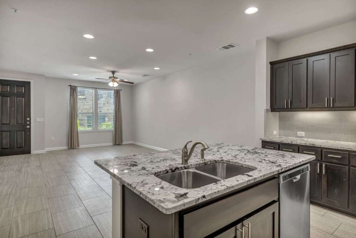 13800 Lyndhurst Street, Unit 223 Austin, TX 78717 - Photo 14 of 40 a kitchen that has a sink and a stove in it