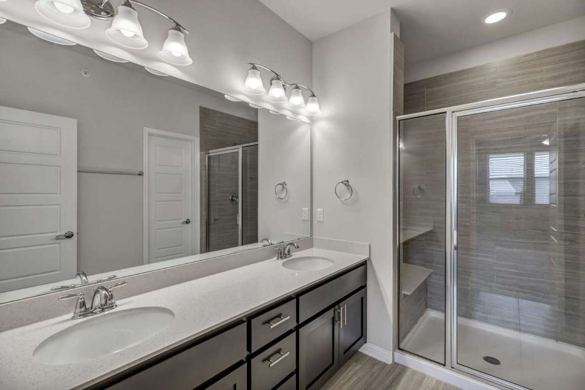 13800 Lyndhurst Street, Unit 223 Austin, TX 78717 - Photo 27 of 40 a bathroom with double vanity sinks and a mirror