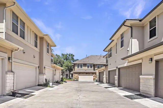 a view of a house with backyard and a tree