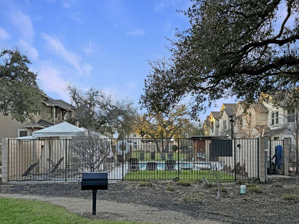 13800 Lyndhurst Street, Unit 223 Austin, TX 78717 - Photo 34 of 40 a front view of a house with garden and trees
