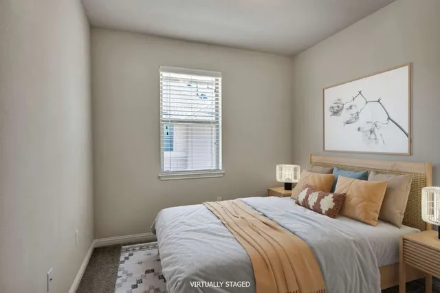 a bedroom with a bed and a window