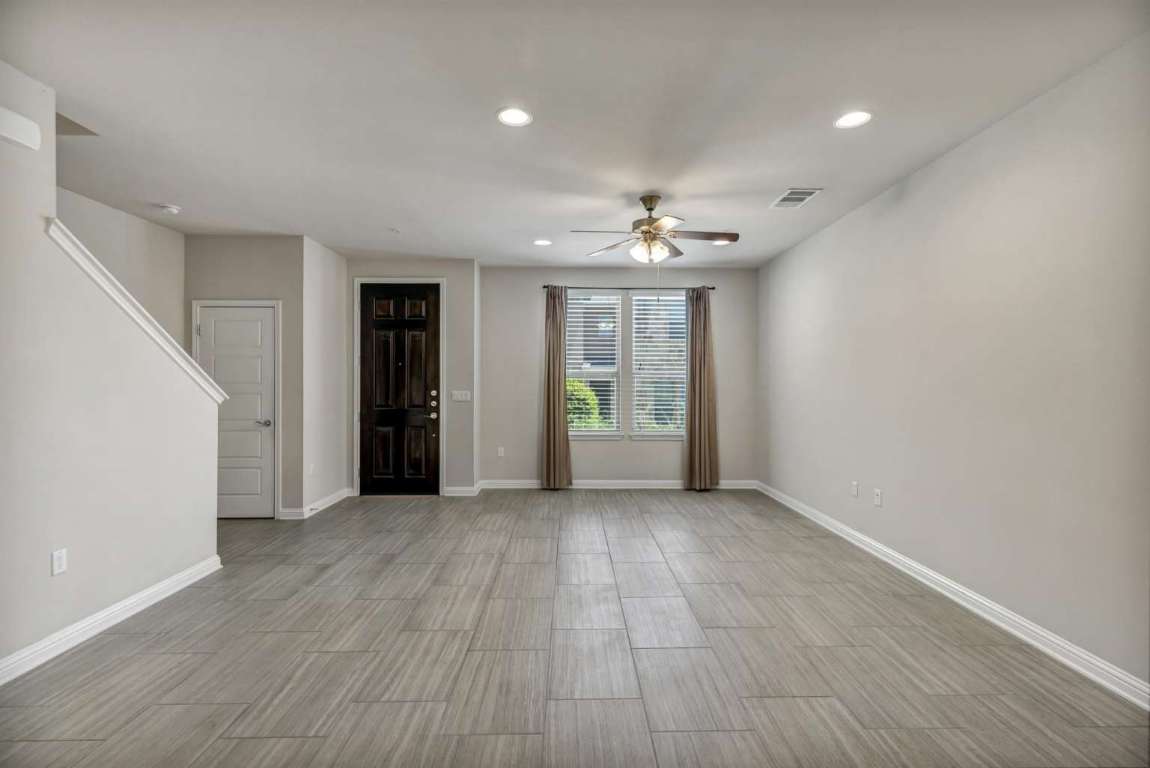 13800 Lyndhurst Street, Unit 223 Austin, TX 78717 - Photo 9 of 40 wooden floor in an empty room with a window