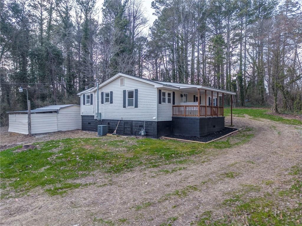 653 Fairview Road Ball Ground, GA 30107 - Photo 6 of 52 a view of a house with a yard