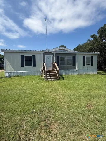 a front view of house with yard and porch