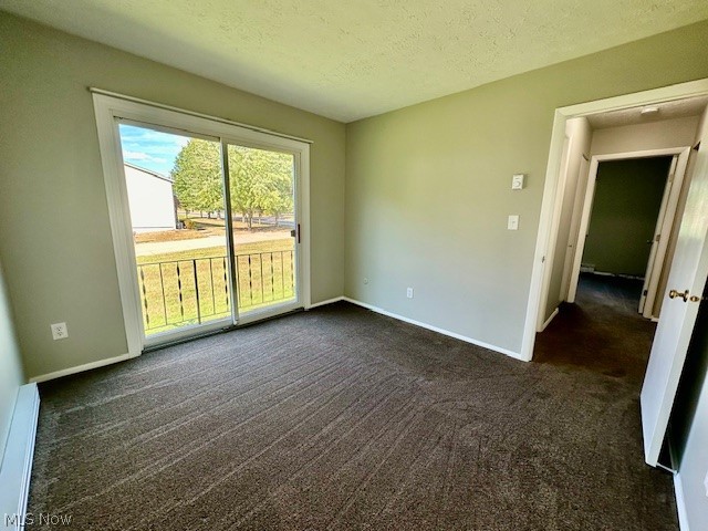 4376 Darrow Road, Unit 7 Stow, OH 44224 - Photo 13 of 23 Empty room featuring a textured ceiling, baseboard heating, and dark carpet