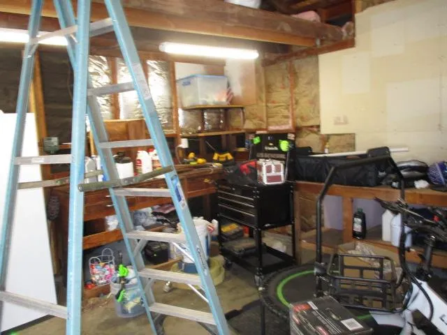 a bedroom with a bed and painting on the wall