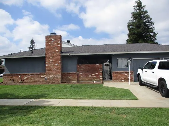 a front view of a house with a garden and pathway