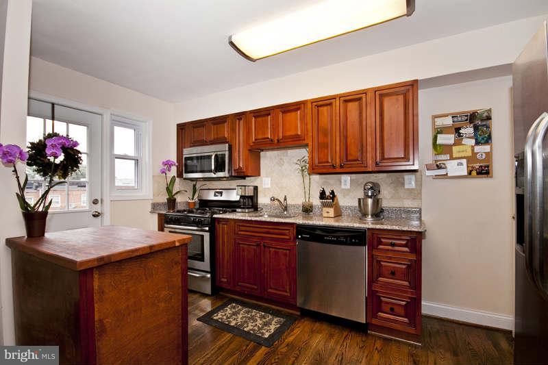 5512 Channing Road Baltimore, MD 21229 - Photo 10 of 29 a kitchen with stainless steel appliances granite countertop a refrigerator sink stove microwave and cabinets