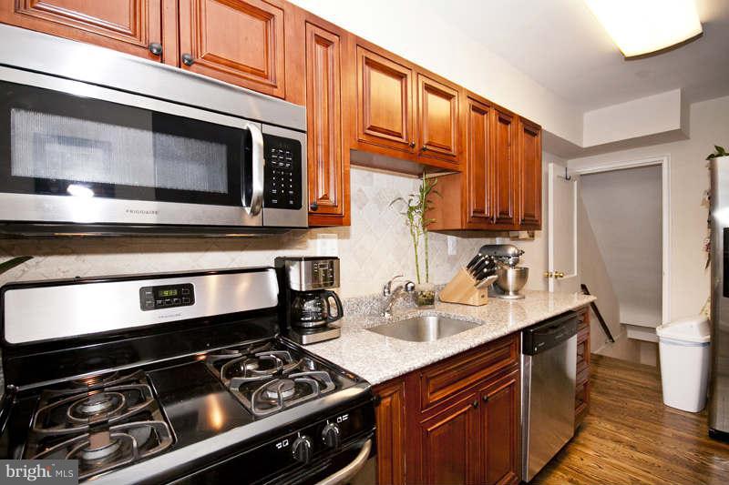 5512 Channing Road Baltimore, MD 21229 - Photo 14 of 29 a kitchen with a stove and a microwave