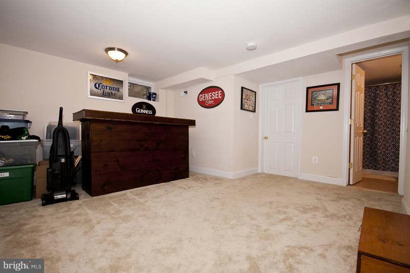 5512 Channing Road Baltimore, MD 21229 - Photo 18 of 29 a bedroom with a bed and a chandelier