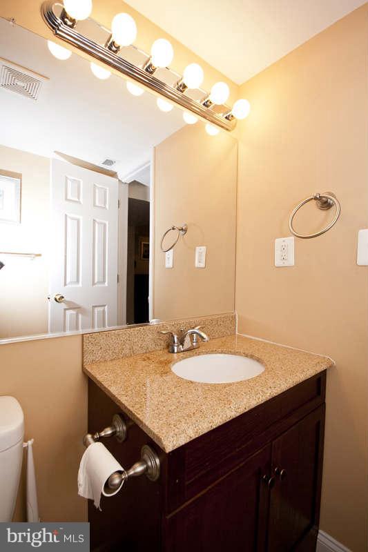 5512 Channing Road Baltimore, MD 21229 - Photo 21 of 29 a bathroom with a sink vanity and a mirror
