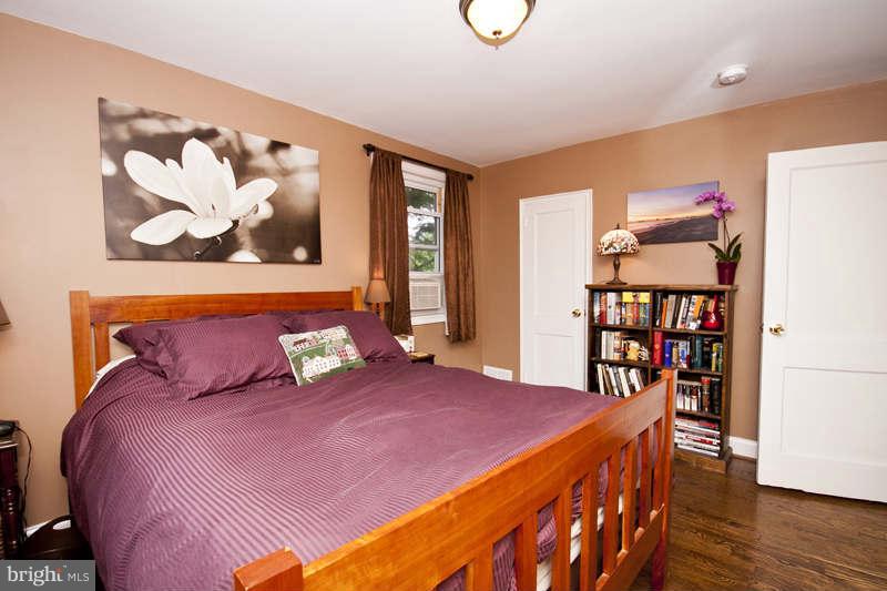 5512 Channing Road Baltimore, MD 21229 - Photo 23 of 29 a bedroom with a bed and wooden floor