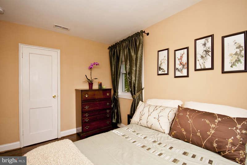 5512 Channing Road Baltimore, MD 21229 - Photo 25 of 29 a bedroom with a bed and a dresser