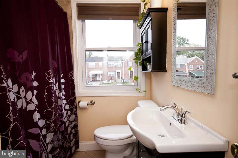 5512 Channing Road Baltimore, MD 21229 - Photo 27 of 29 a bathroom with a sink toilet and mirror