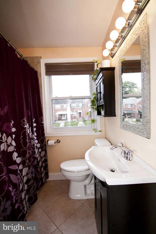 5512 Channing Road Baltimore, MD 21229 - Photo 28 of 29 a bathroom with a sink toilet and a mirror