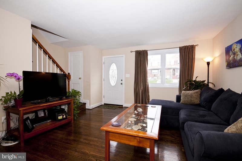 5512 Channing Road Baltimore, MD 21229 - Photo 5 of 29 a living room with furniture and a flat screen tv