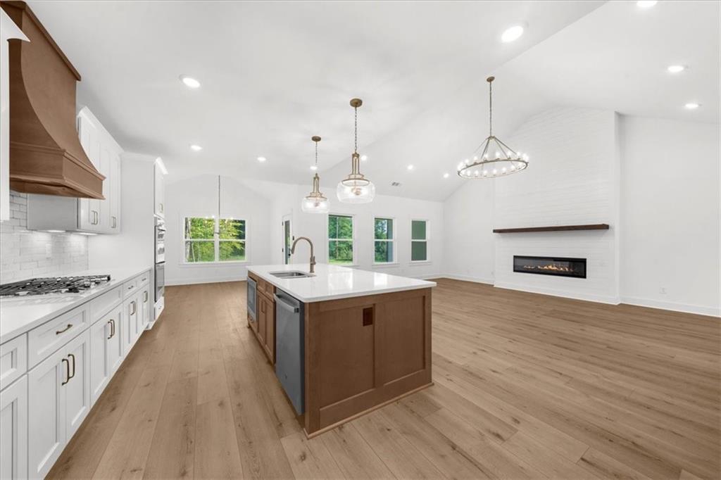 502 Level Creek Road Sugar Hill, GA 30518 - Photo 13 of 54 a large kitchen with stainless steel appliances granite countertop a stove and a wooden floors