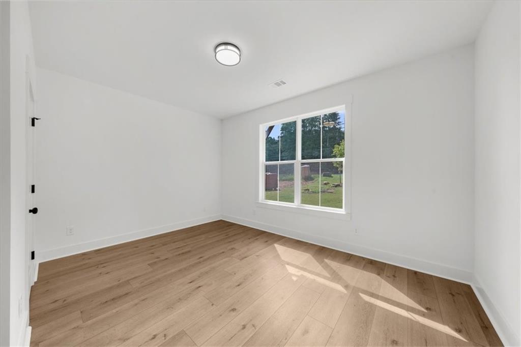 502 Level Creek Road Sugar Hill, GA 30518 - Photo 20 of 54 an empty room with a window