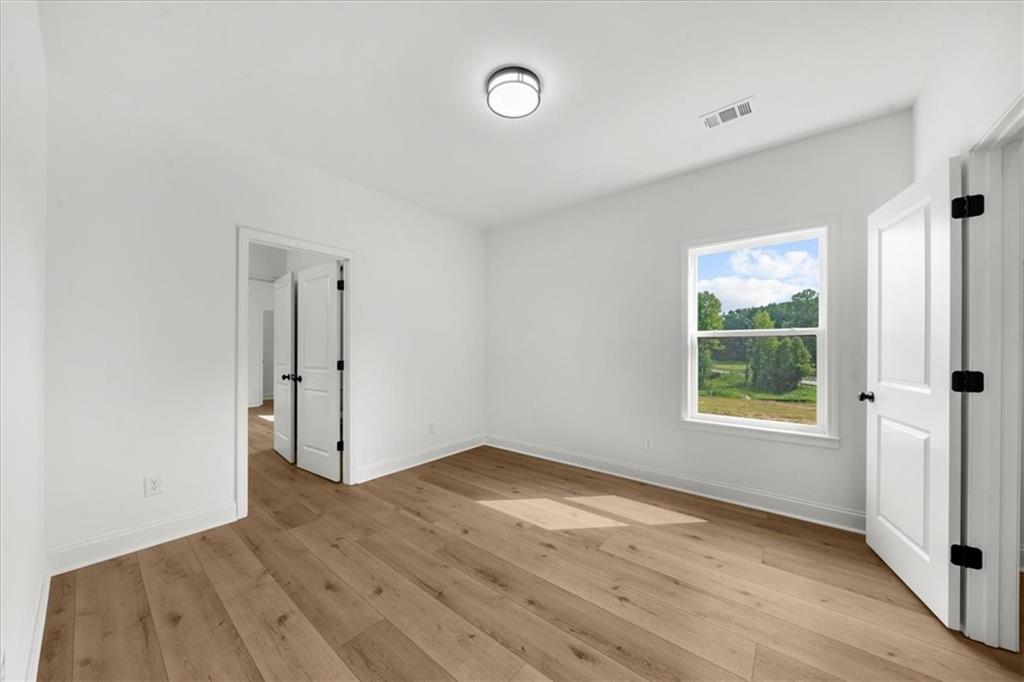 502 Level Creek Road Sugar Hill, GA 30518 - Photo 30 of 54 wooden floor in an empty room with a window