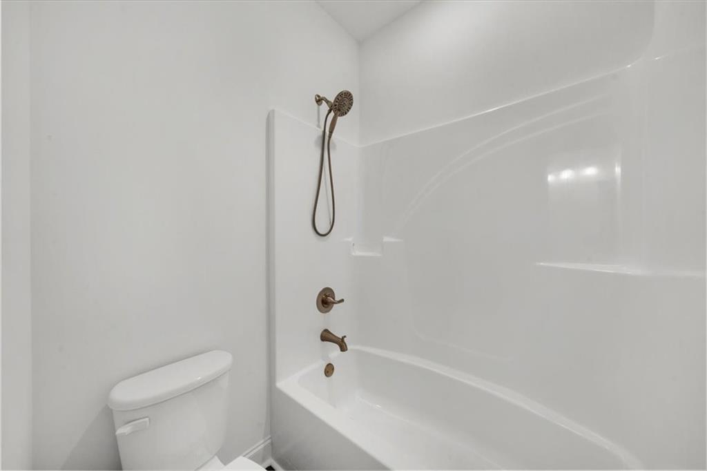 502 Level Creek Road Sugar Hill, GA 30518 - Photo 33 of 54 a bathroom with a shower a toilet and a shower