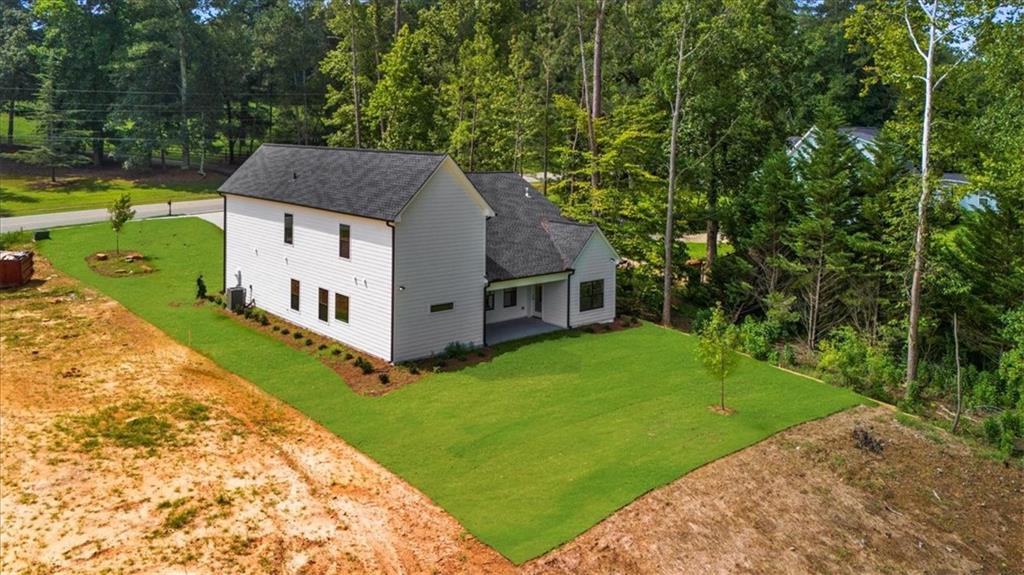 502 Level Creek Road Sugar Hill, GA 30518 - Photo 50 of 54 a aerial view of a house next to a big yard and large trees