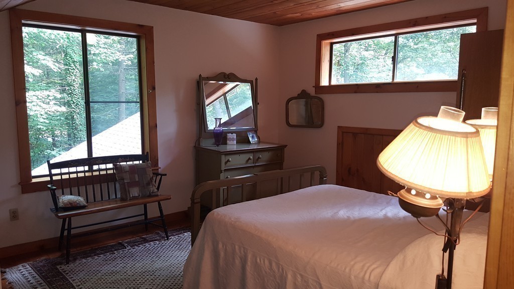 9 Pine Tree Circle Pelham, MA 01002 - Photo 20 of 30 a bedroom with a bed a mirror and a window