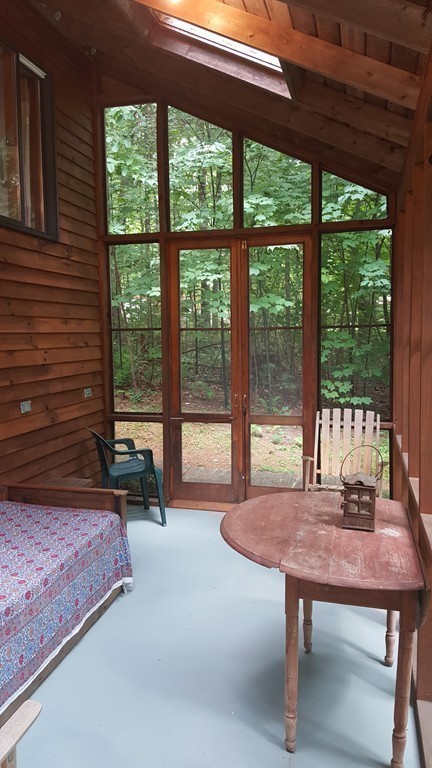 9 Pine Tree Circle Pelham, MA 01002 - Photo 7 of 30 a living room with a table chair and a large window