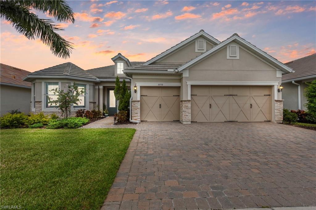 10530 Jackson Square Drive Estero, FL 33928 - Photo 1 of 48 a front view of a house with a yard and garage