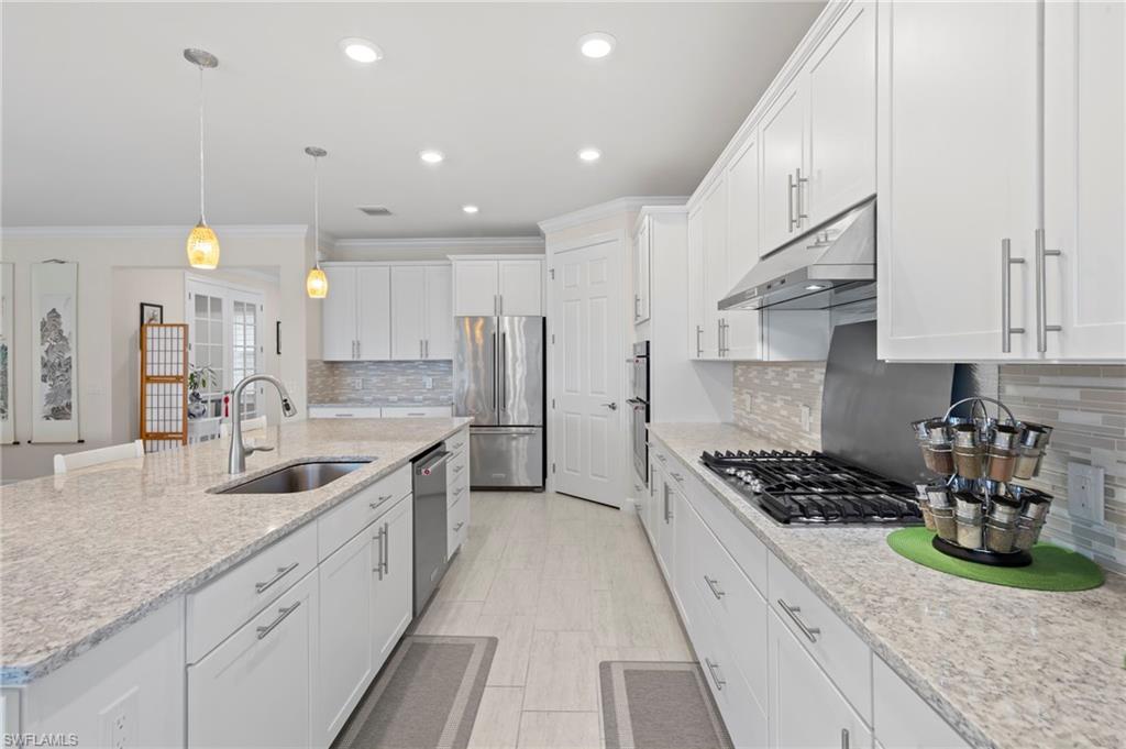 10530 Jackson Square Drive Estero, FL 33928 - Photo 13 of 48 a kitchen with stainless steel appliances granite countertop a sink stove and cabinets