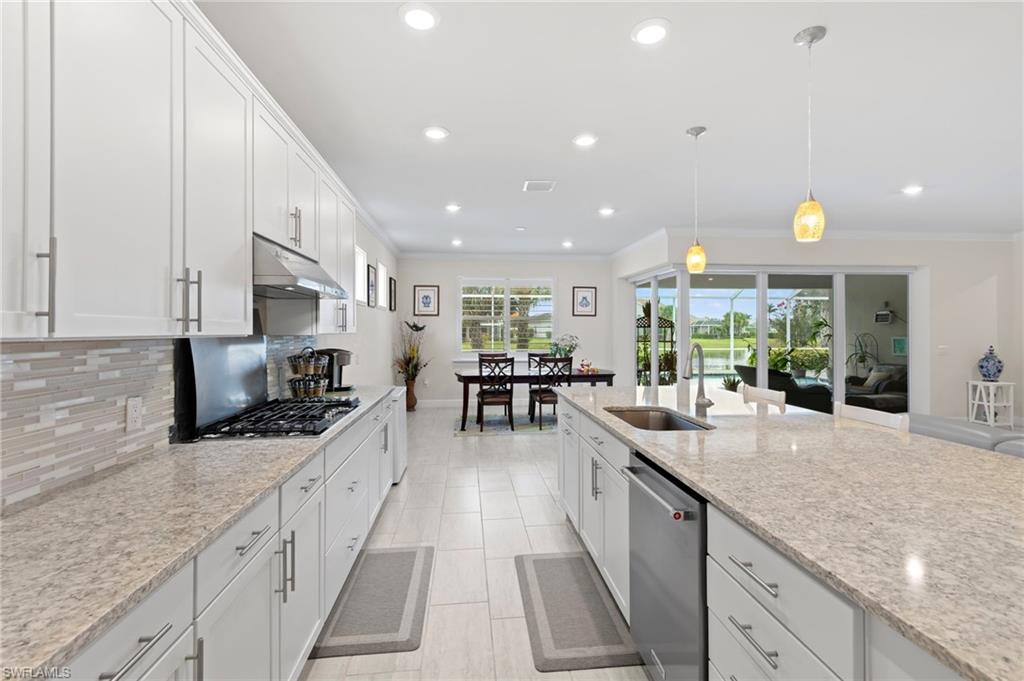 10530 Jackson Square Drive Estero, FL 33928 - Photo 14 of 48 a large kitchen with stainless steel appliances granite countertop a sink and counter space