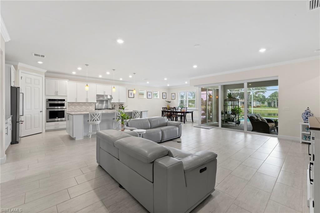 10530 Jackson Square Drive Estero, FL 33928 - Photo 19 of 48 a living room with furniture and a kitchen view