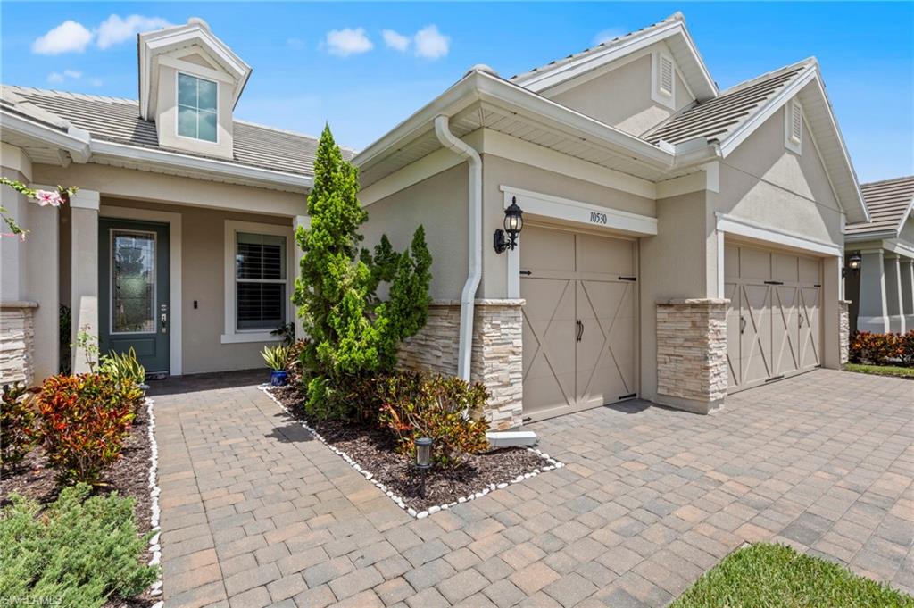 10530 Jackson Square Drive Estero, FL 33928 - Photo 2 of 48 a view of a house with potted plants