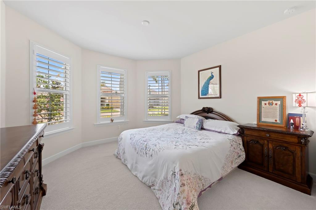 10530 Jackson Square Drive Estero, FL 33928 - Photo 25 of 48 a bed sitting in a bedroom next to a window