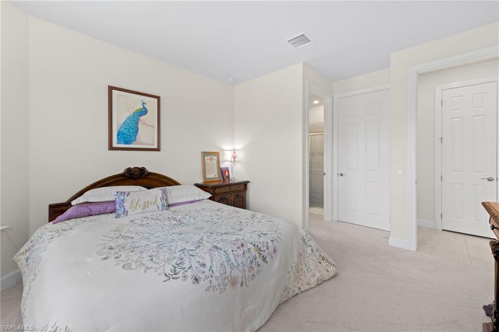 10530 Jackson Square Drive Estero, FL 33928 - Photo 26 of 48 a bedroom with a bed and a painting