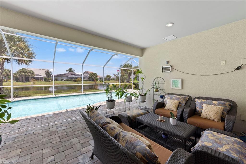10530 Jackson Square Drive Estero, FL 33928 - Photo 33 of 48 a living room with furniture and a floor to ceiling window