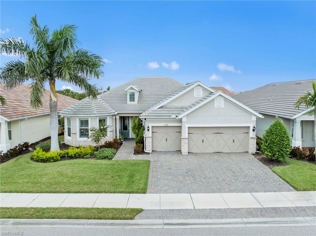 10530 Jackson Square Drive Estero, FL 33928 - Photo 38 of 48 a front view of a house with a yard and garage