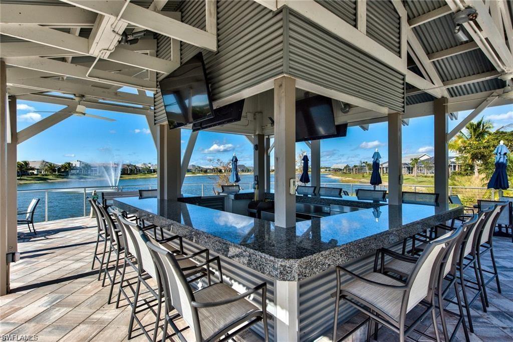 10530 Jackson Square Drive Estero, FL 33928 - Photo 47 of 48 a view of a patio with dining table and chairs with a barbeque grill and couches