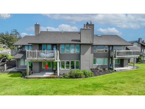 a view of a house with a backyard porch and sitting area