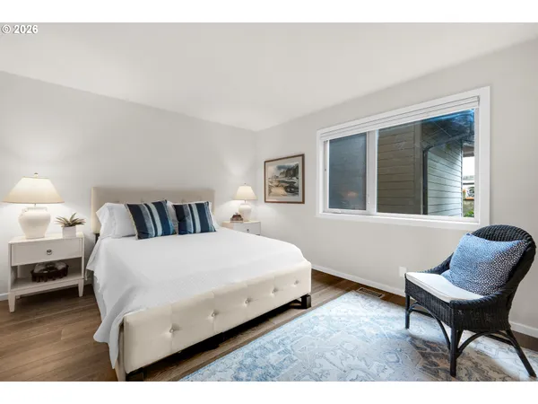 a bedroom with a bed a table and chair