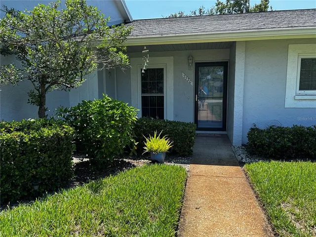 a view of a house with potted plants