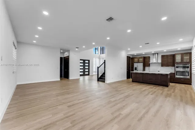 a view of a kitchen with a sink and a stove top oven