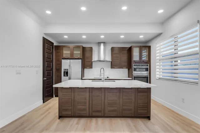 a view of a kitchen counter top space with stainless steel appliances cabinets