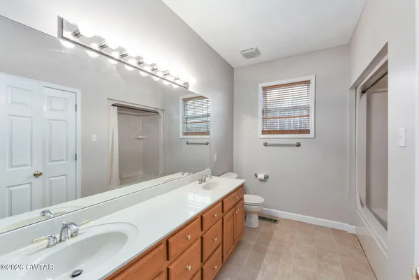 a bathroom with a double vanity sink and a mirror