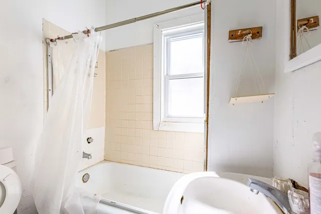 a clock on a wall next to a window