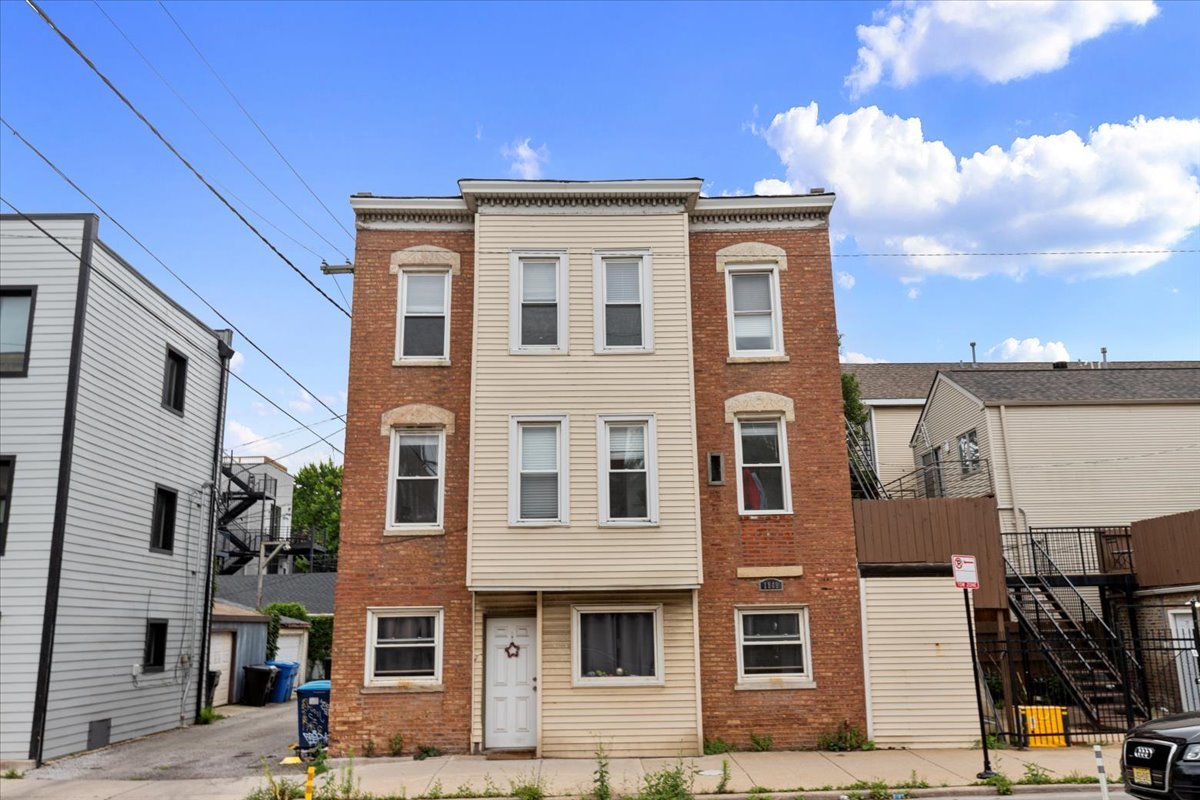 1849 West Augusta Boulevard, Unit 3 Chicago, IL 60622 - Photo 1 of 11 a front view of a building with many windows