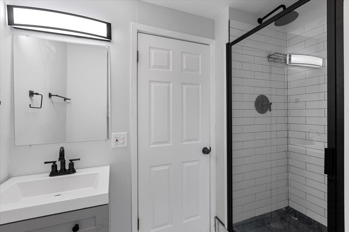 1849 West Augusta Boulevard, Unit 3 Chicago, IL 60622 - Photo 11 of 11 a bathroom with a sink a mirror and shower