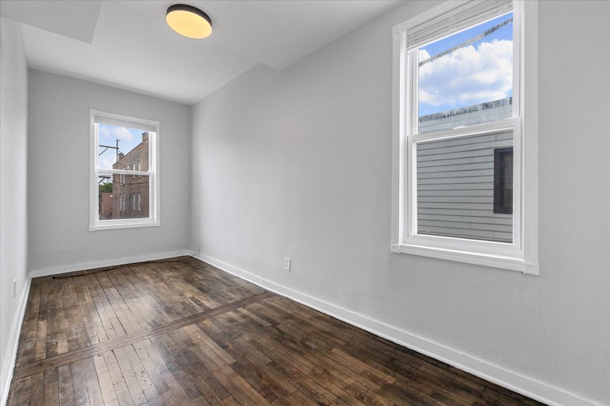 1849 West Augusta Boulevard, Unit 3 Chicago, IL 60622 - Photo 8 of 11 an empty room with windows
