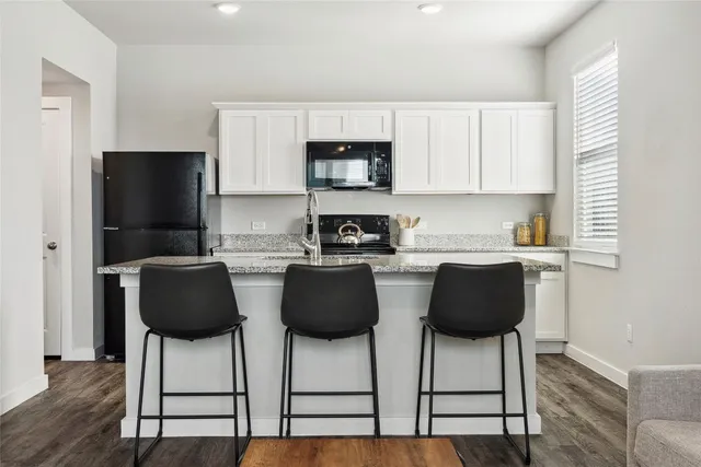 a living room with furniture a rug and a window